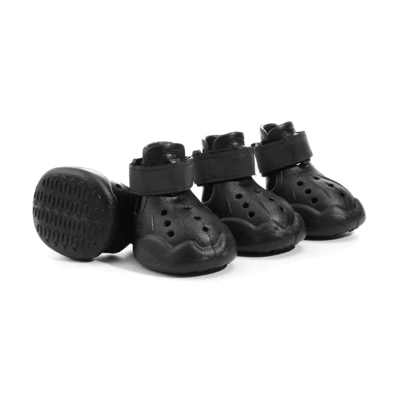 Set of black dog boots with straps on a white background